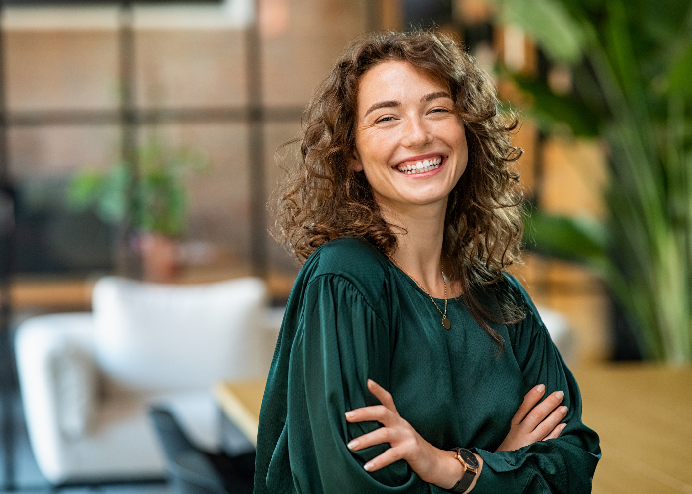 a smiling woman with her hands crossed feeling very confident